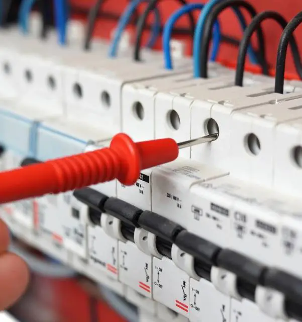 A person is working on an electrical panel.