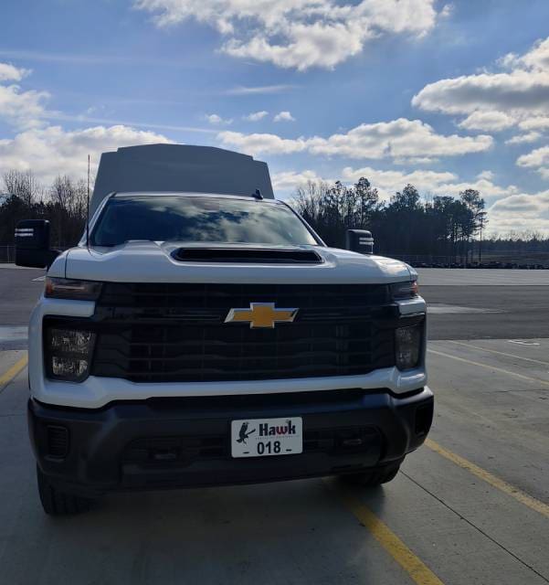 A white truck is parked on the side of the road.