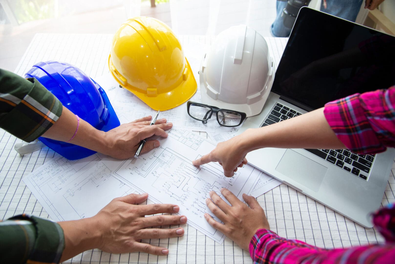 A group of people sitting at a table with construction equipment.