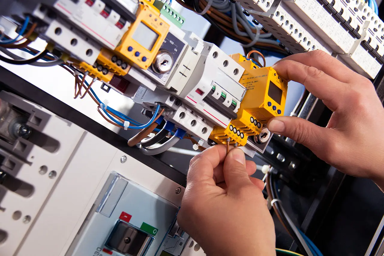 A person is working on an electrical panel.